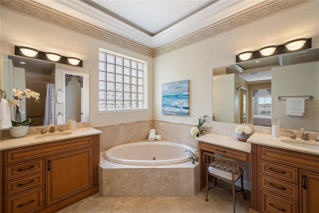 8119 Vía Rosa Orlando, FL 32836 - Photo 22 of 62 a bathroom with a granite countertop tub double vanity sink and a mirror