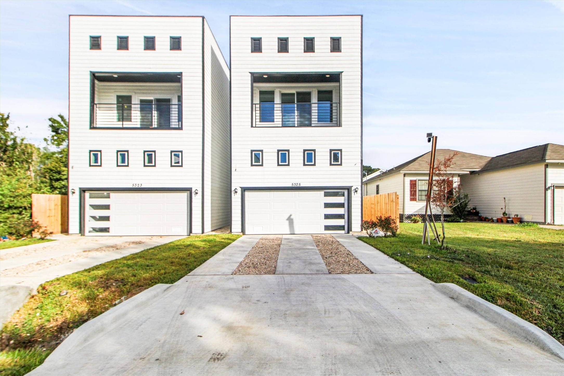 5323 Rue Street Houston, TX 77033 - Photo 1 of 34 a front view of a house with a yard and garage