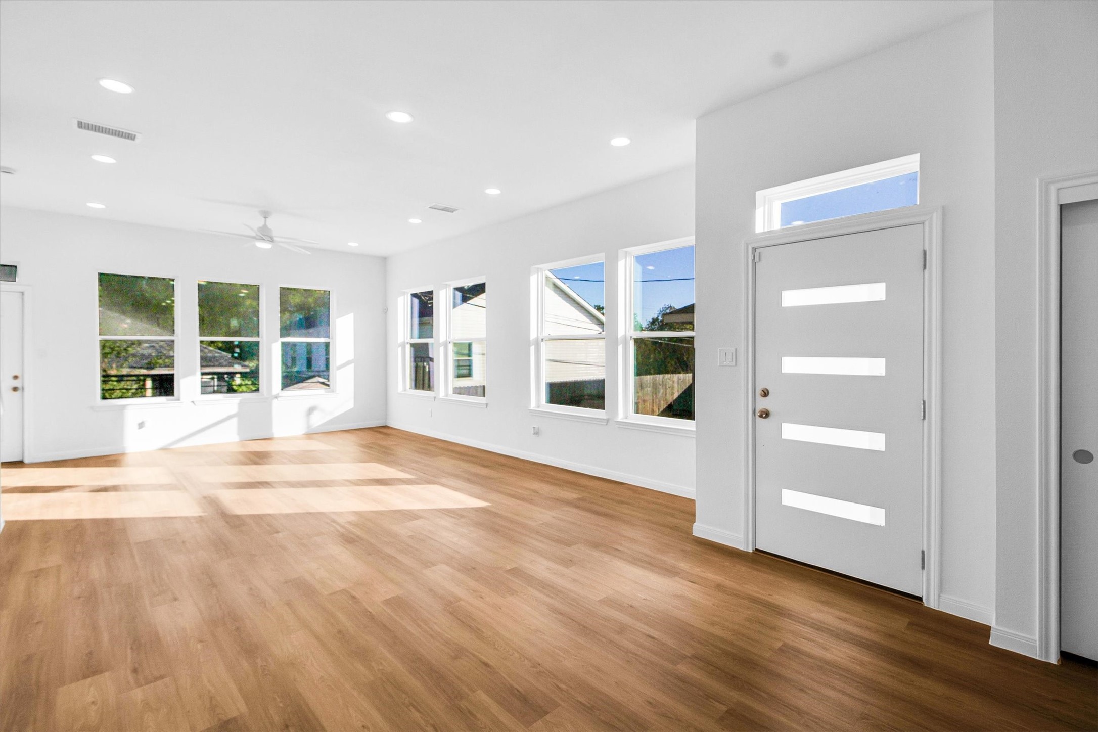 5323 Rue Street Houston, TX 77033 - Photo 2 of 34 a view of an empty room with wooden floor and windows