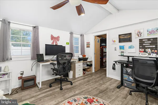 a view of a workspace with furniture and a window