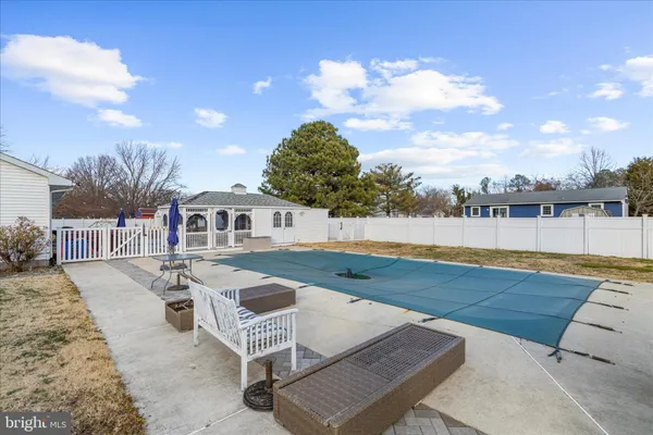 a view of a swimming pool with lounge chairs