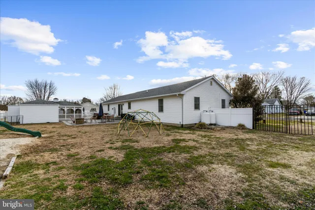 a view of a backyard with table and chairs