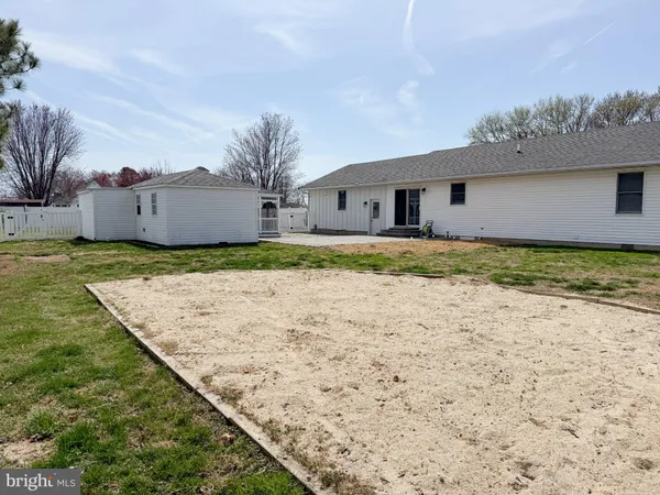 a view of a house with a yard and fence