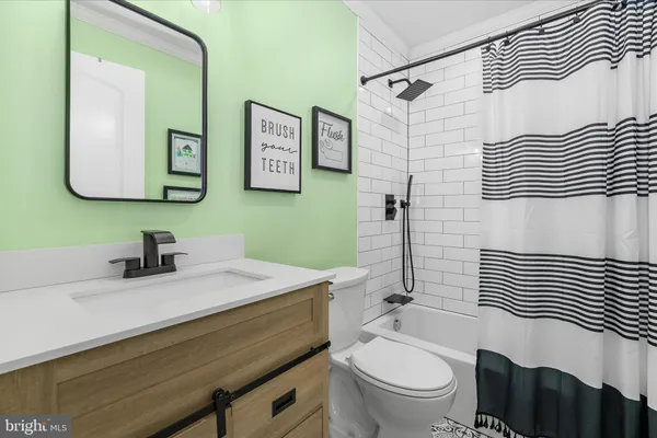 a bathroom with a sink a toilet and mirror