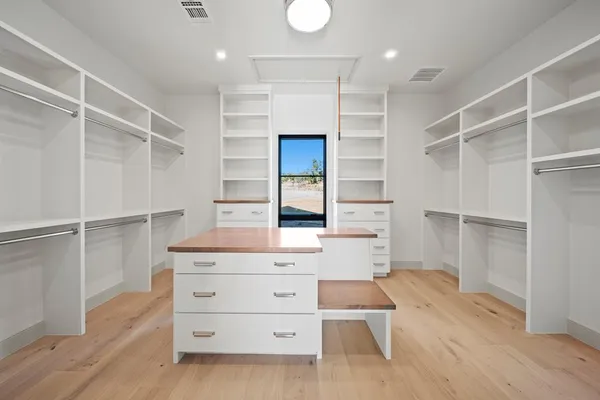 a kitchen with a stove and white cabinets