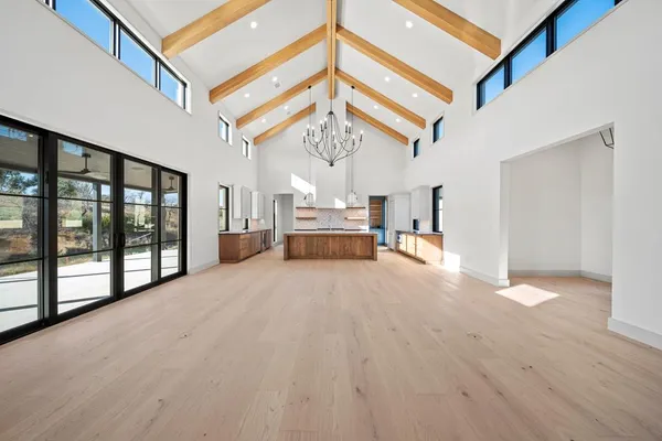 a view of a big room with chandelier and windows