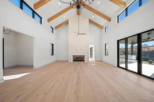 a view of empty room with wooden floor and fireplace