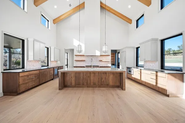 a large kitchen with stainless steel appliances kitchen island granite countertop a large counter top and stove