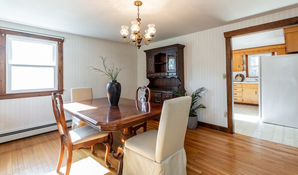 159 Hathaway Road Acushnet, MA 02743 - Photo 6 of 18 a dining room with furniture potted plants and wooden floor