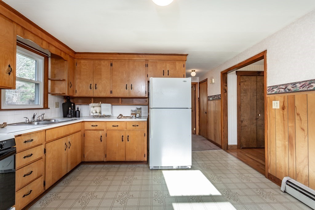 159 Hathaway Road Acushnet, MA 02743 - Photo 8 of 18 a kitchen with sink a refrigerator and white cabinets