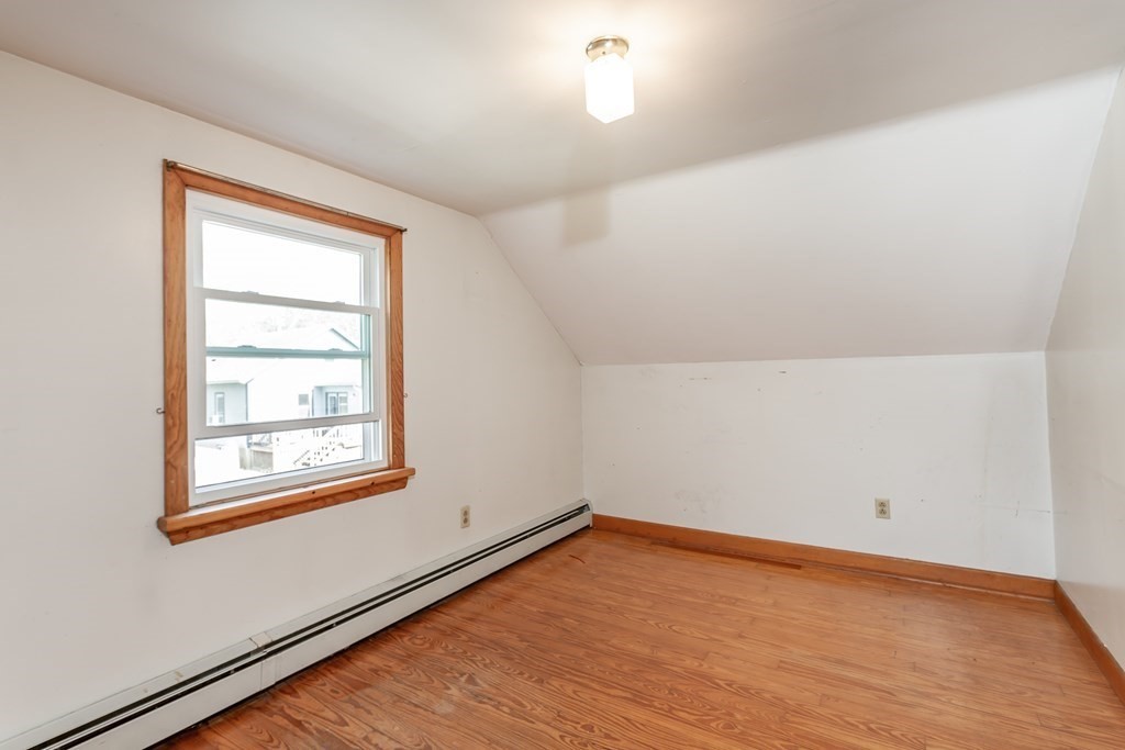 159 Hathaway Road Acushnet, MA 02743 - Photo 10 of 18 an empty room with wooden floor and windows