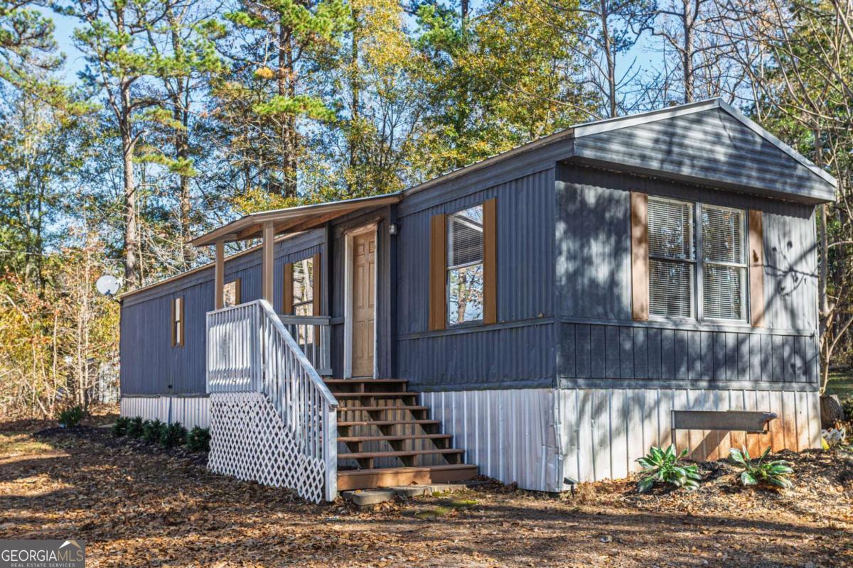 139 Anglin Road Jefferson, GA 30549 - Photo 1 of 26 a front view of a house with a garden
