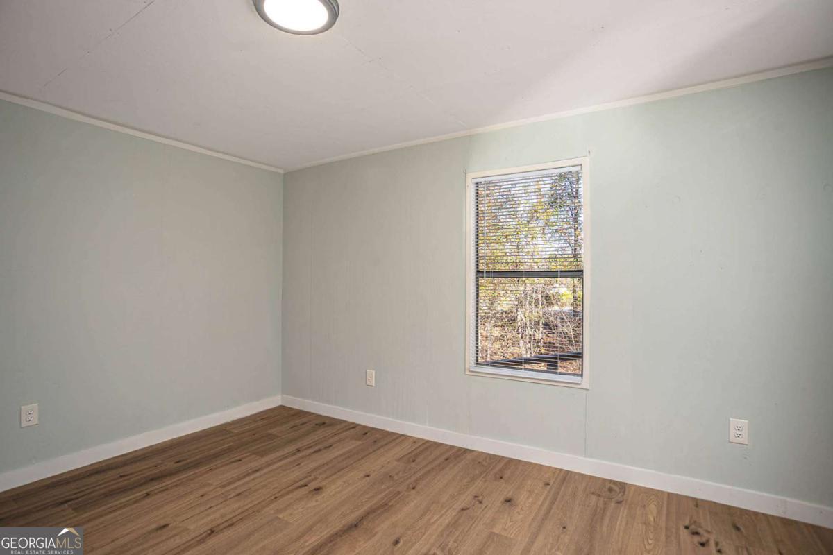 139 Anglin Road Jefferson, GA 30549 - Photo 14 of 26 an empty room with wooden floor and windows
