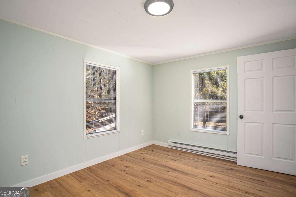 139 Anglin Road Jefferson, GA 30549 - Photo 15 of 26 an empty room with wooden floor and windows