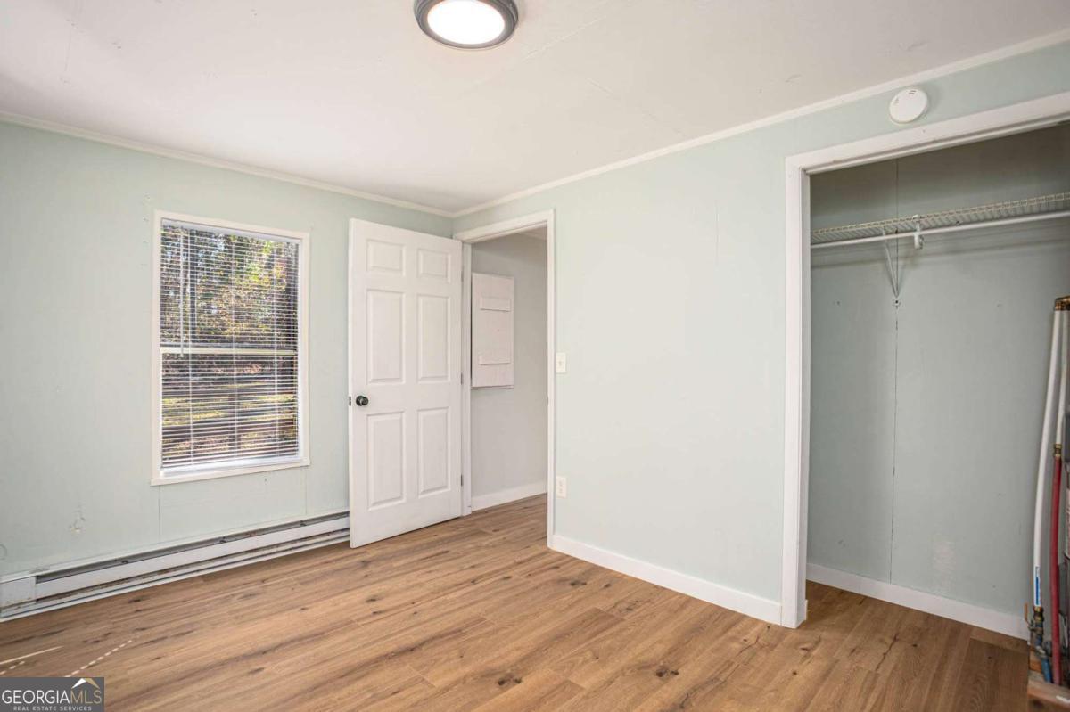 139 Anglin Road Jefferson, GA 30549 - Photo 16 of 26 a view of an empty room with wooden floor and a window