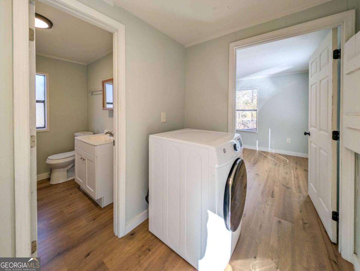 139 Anglin Road Jefferson, GA 30549 - Photo 19 of 26 a en suite bathroom with a sink a toilet and a mirror