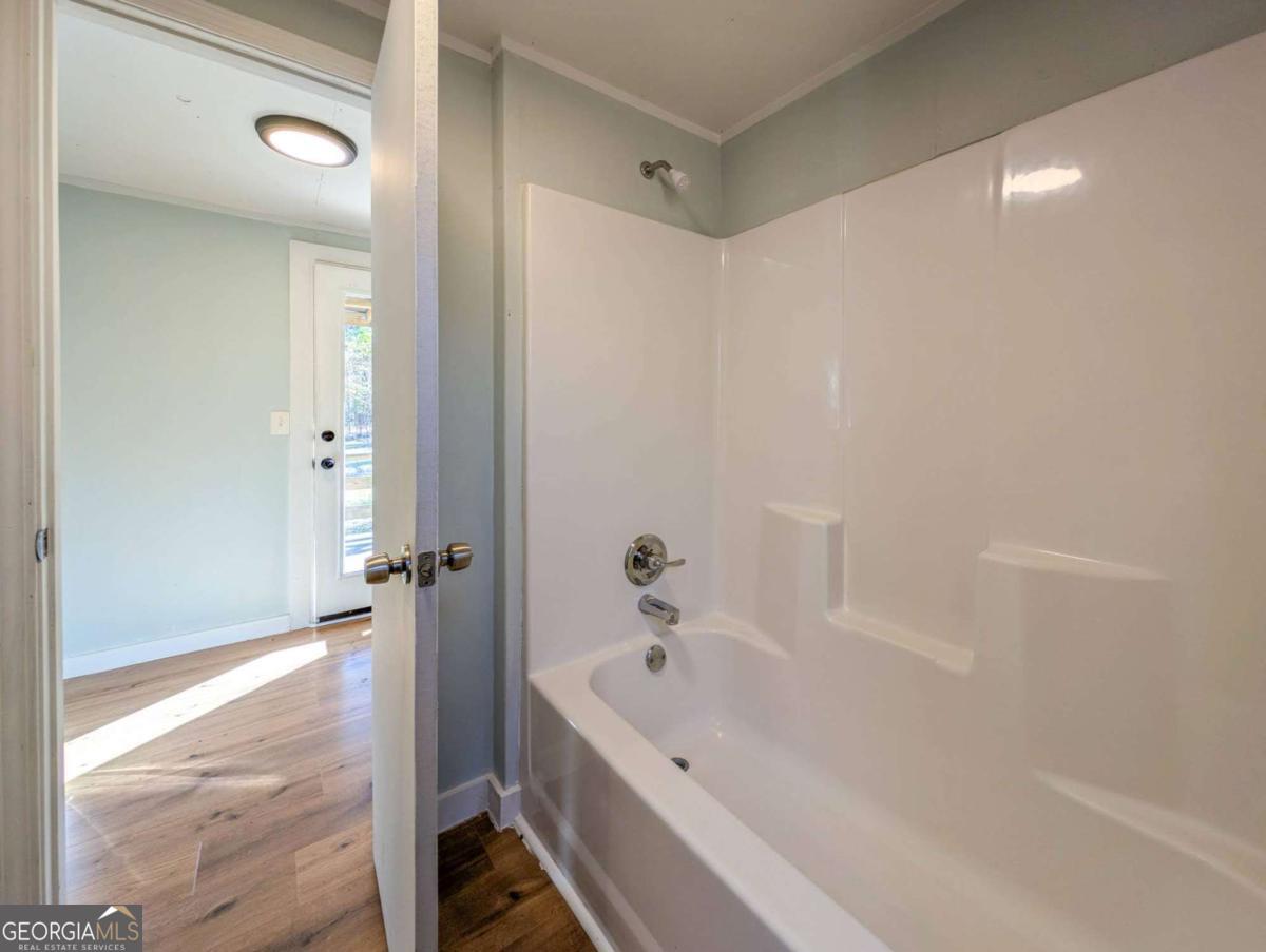 139 Anglin Road Jefferson, GA 30549 - Photo 21 of 26 a bathroom with a bathtub and a shower