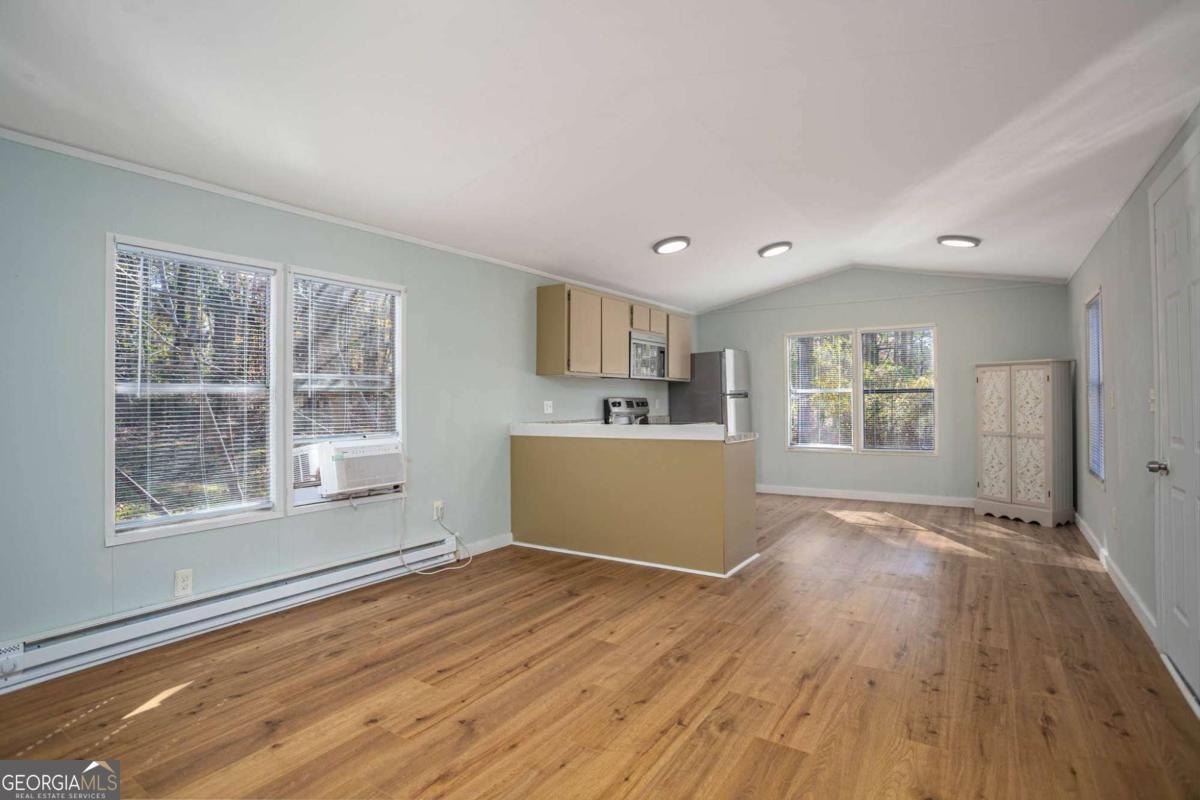 139 Anglin Road Jefferson, GA 30549 - Photo 5 of 26 a view of a kitchen with wooden floor and windows