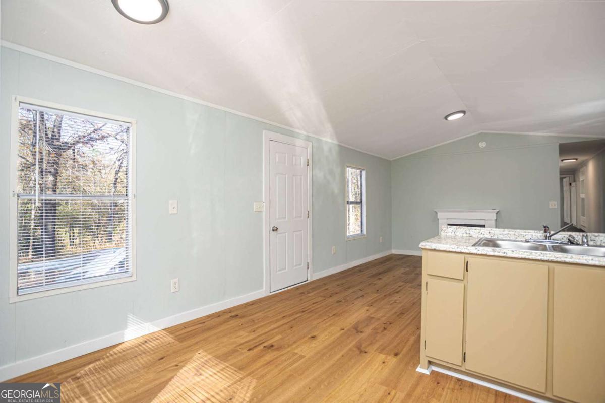 139 Anglin Road Jefferson, GA 30549 - Photo 6 of 26 a view of a kitchen with wooden floor and a window