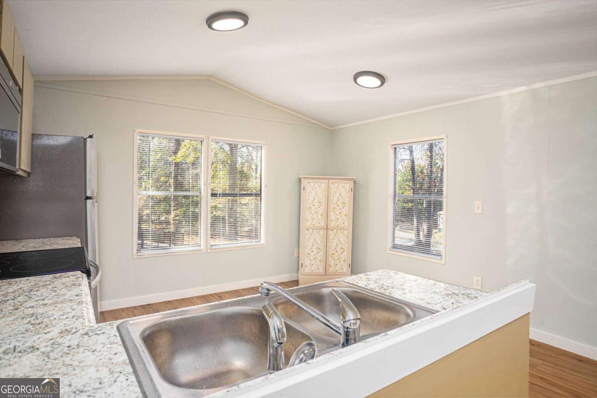 139 Anglin Road Jefferson, GA 30549 - Photo 10 of 26 a kitchen with a sink granite countertops and a window