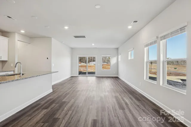 a view of a kitchen with a sink and wooden floor