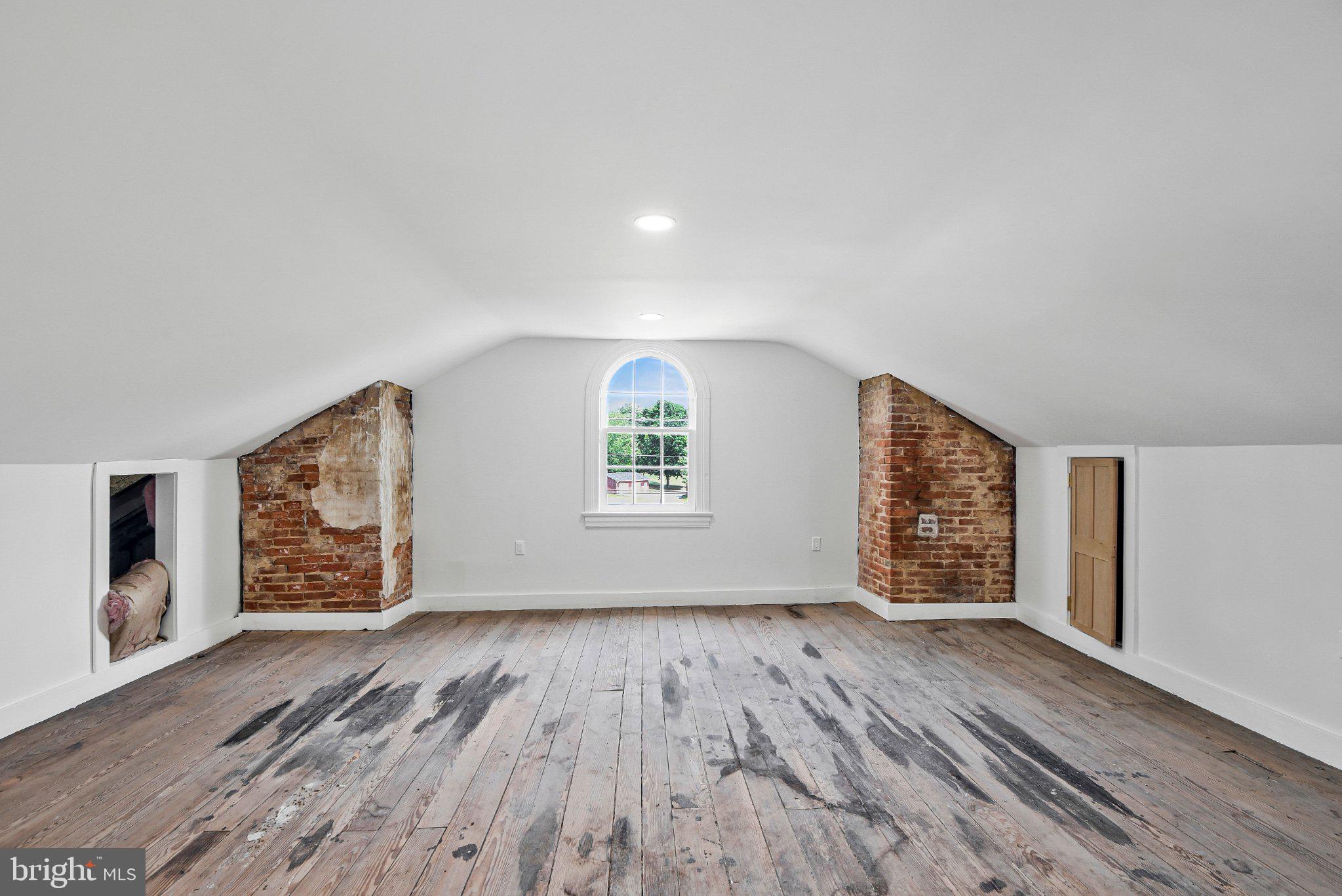 22109 Aquasco Road Aquasco, MD 20608 - Photo 29 of 34 Charming attic with rustic brick accents.