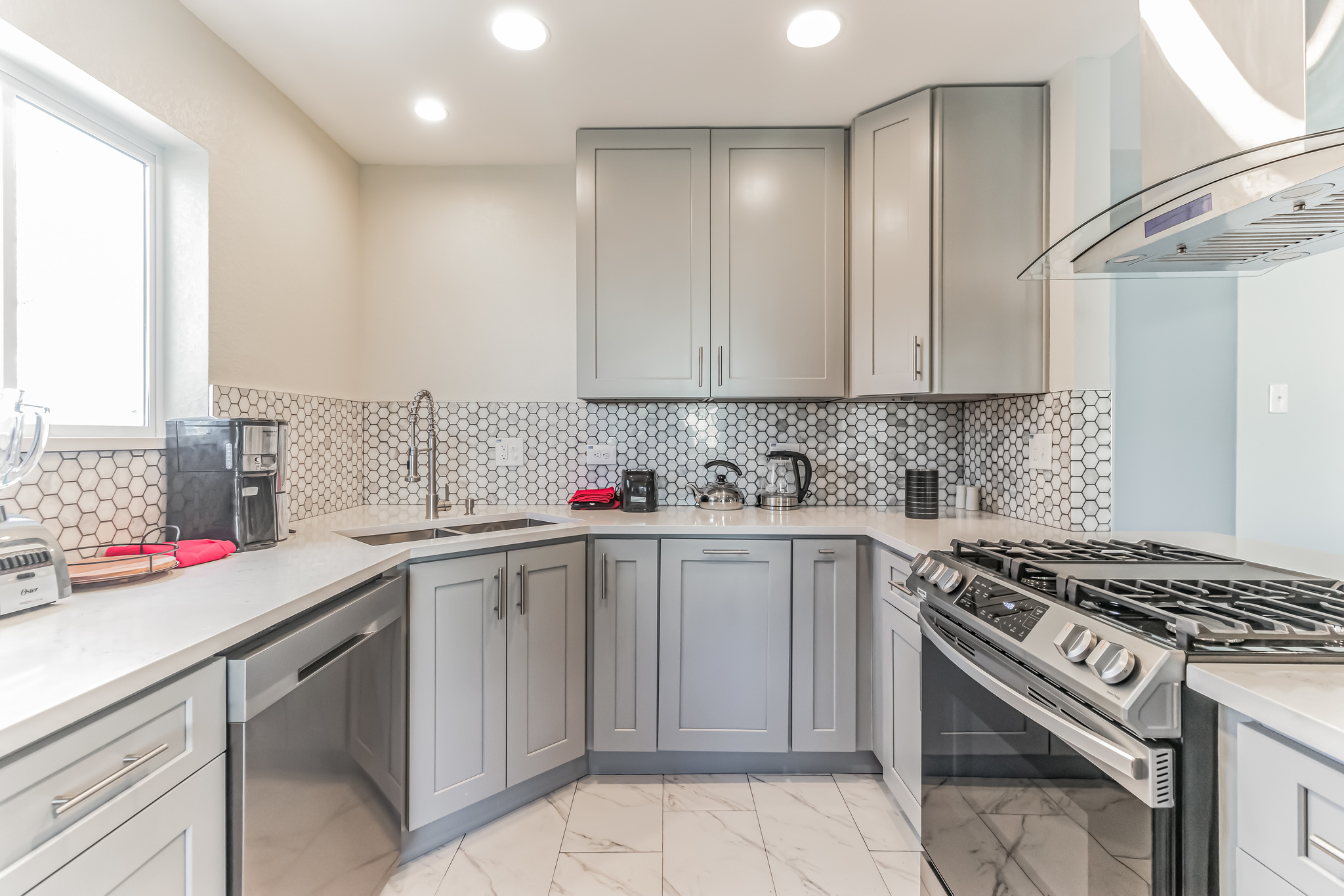 11406 Ruffed Grouse Drive Austin, TX 78758 - Photo 3 of 22 Gleaming stone countertops and a modern patterned tile backsplash define this functional workspace.