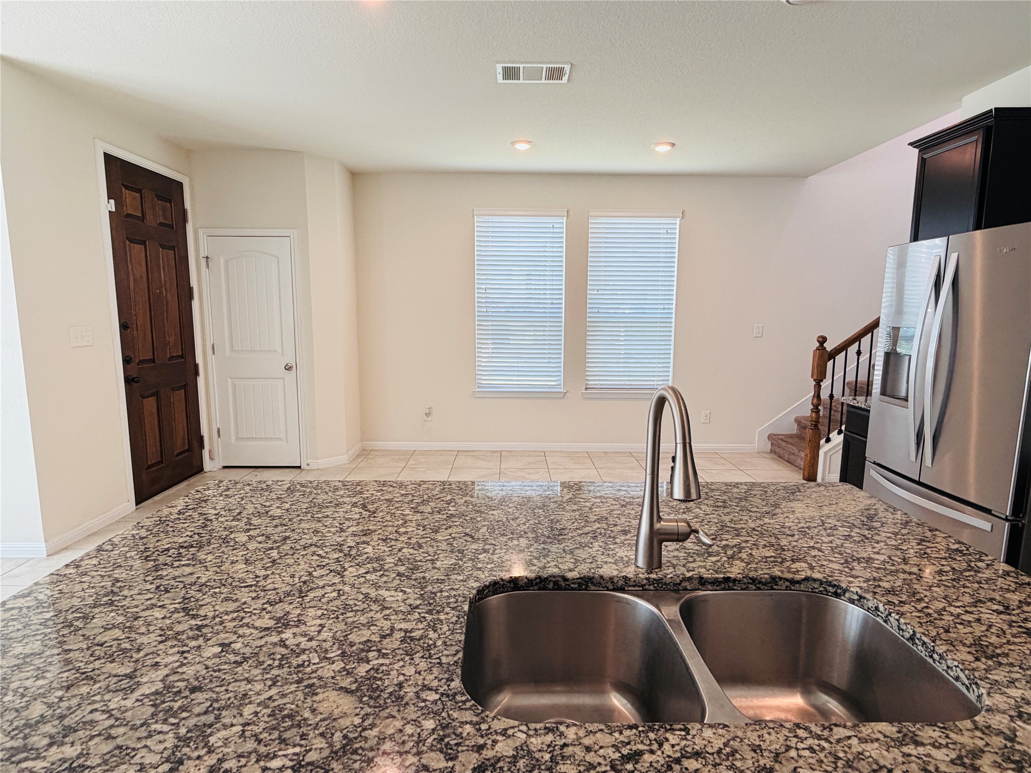 2013 Hat Bender Loop Round Rock, TX 78664 - Photo 16 of 16 Kitchen featuring stainless steel fridge, dark stone counters, and light tile patterned floors
