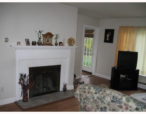 3424 Diamond Hill Road Cumberland, RI 02864 - Photo 6 of 8 Living Room. Fireplaced living room with glass door to large back yard