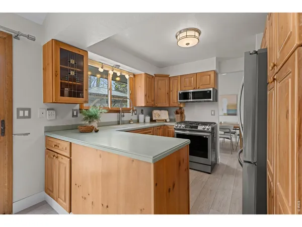 a kitchen with a refrigerator stove and sink