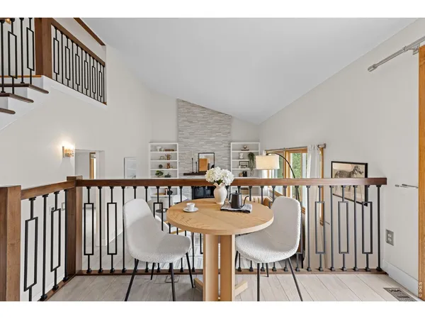 a dining room with furniture a rug and wooden floor
