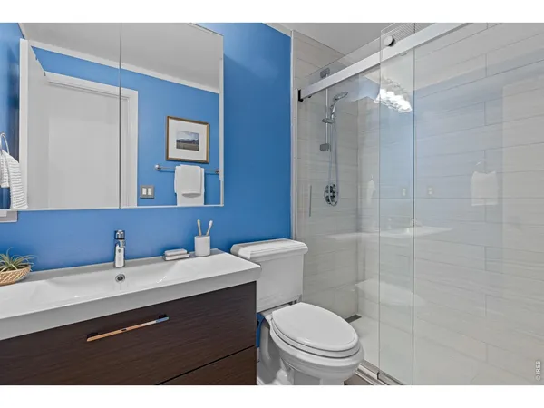 a bathroom with a sink toilet a mirror and shower