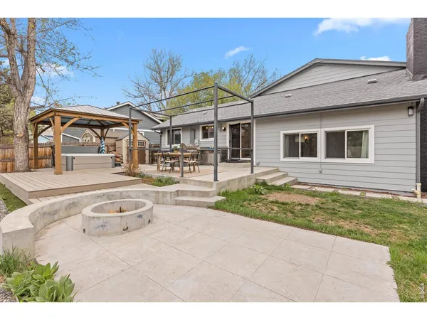 a backyard of a house with outdoor seating