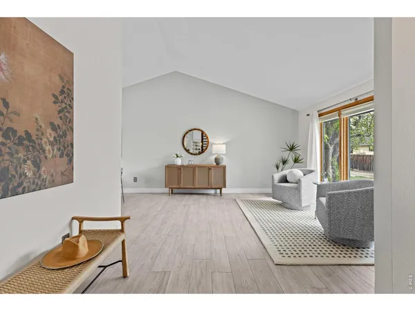a living room with furniture and a clock