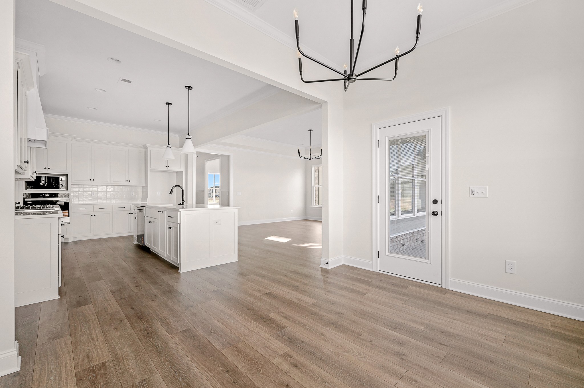 4209 McCown Way Murfreesboro, TN 37127 - Photo 11 of 29 a view of a kitchen and empty room with wooden floor