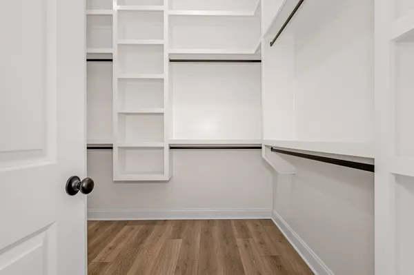 a view of walk in closet with empty racks