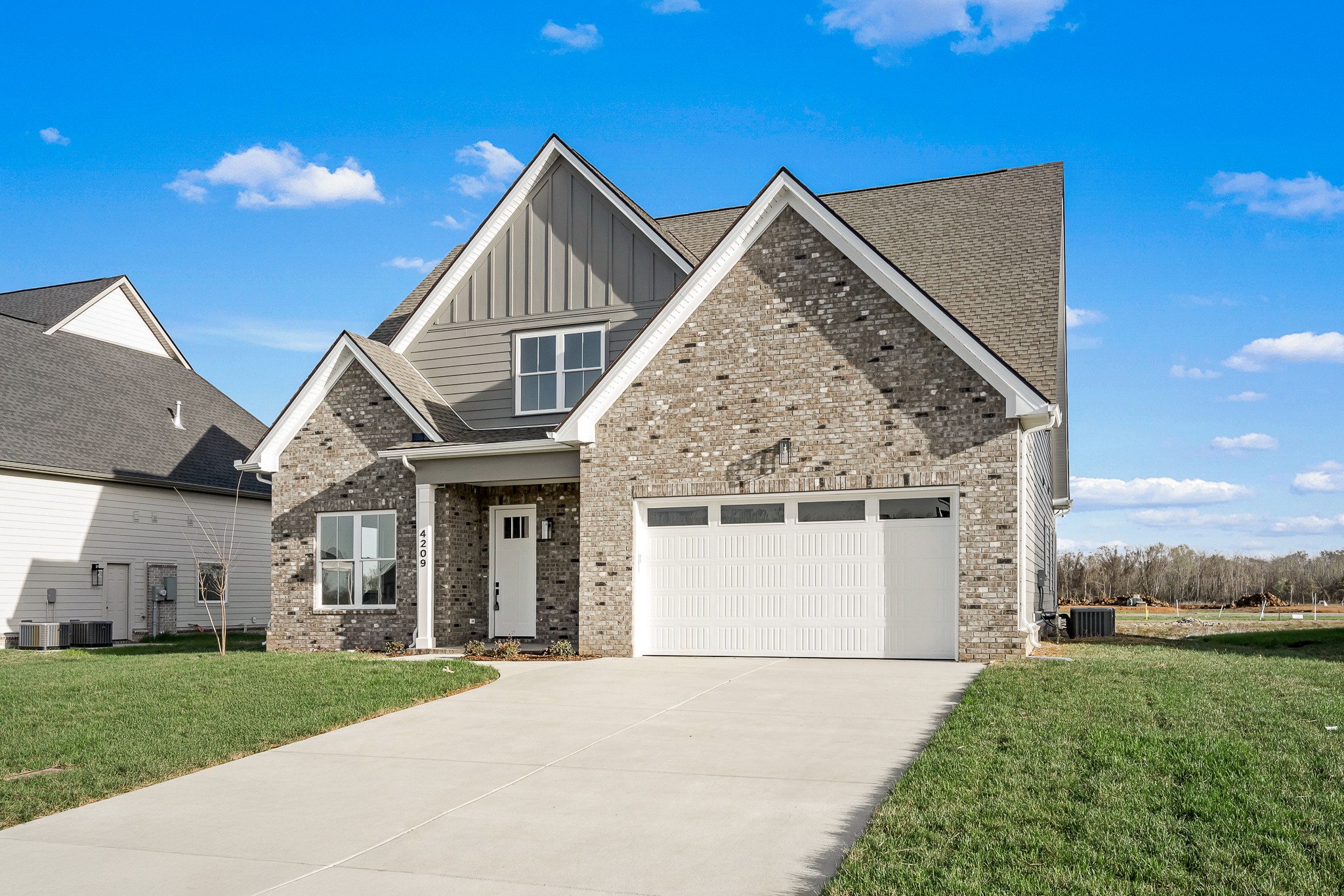 4209 McCown Way Murfreesboro, TN 37127 - Photo 4 of 29 a front view of a house with a yard and garage