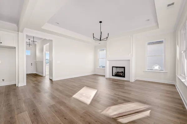 a view of a hallway with wooden floor and a fireplace