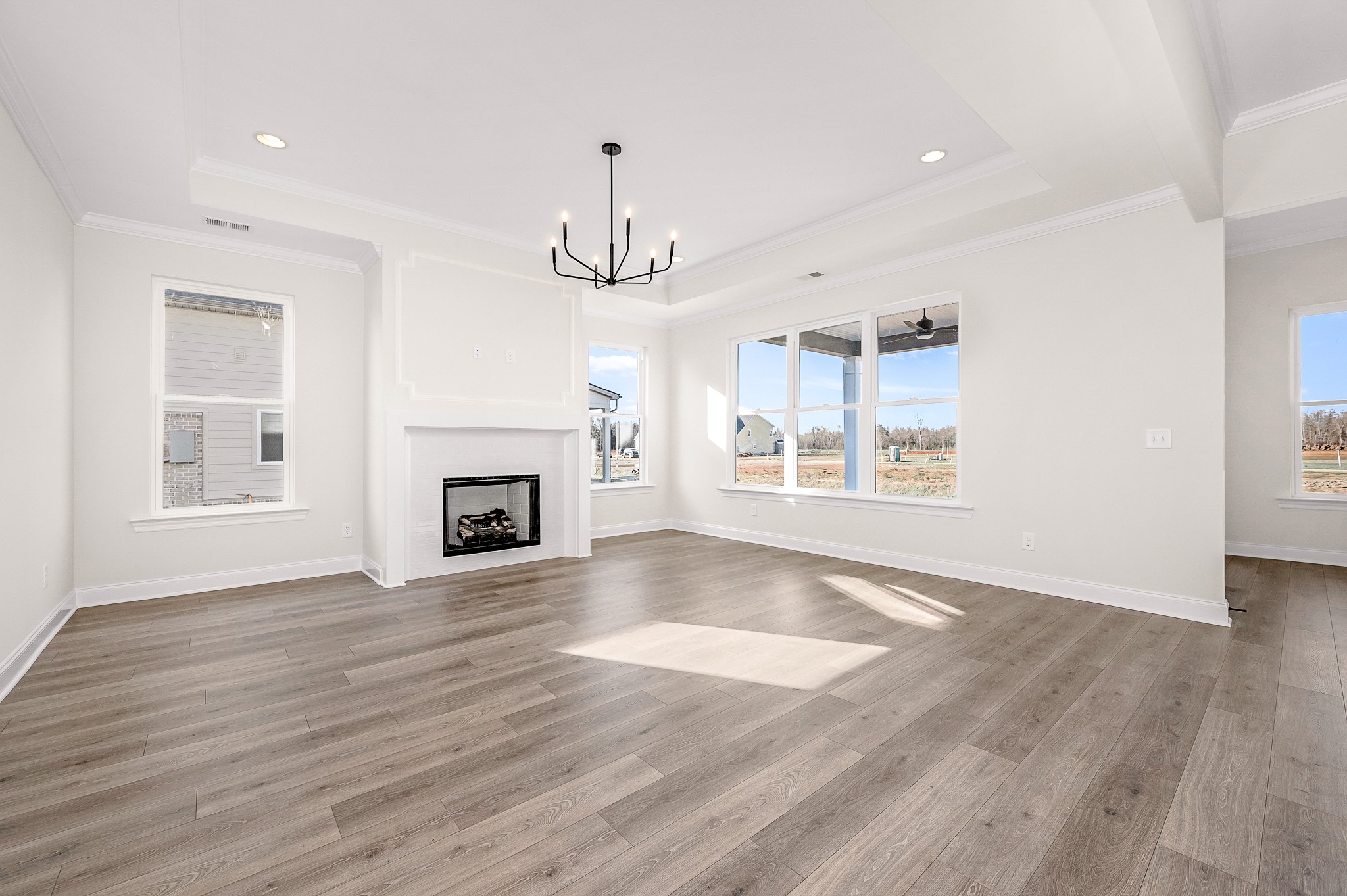 4209 McCown Way Murfreesboro, TN 37127 - Photo 7 of 29 a view of an empty room with wooden floor fireplace and a window