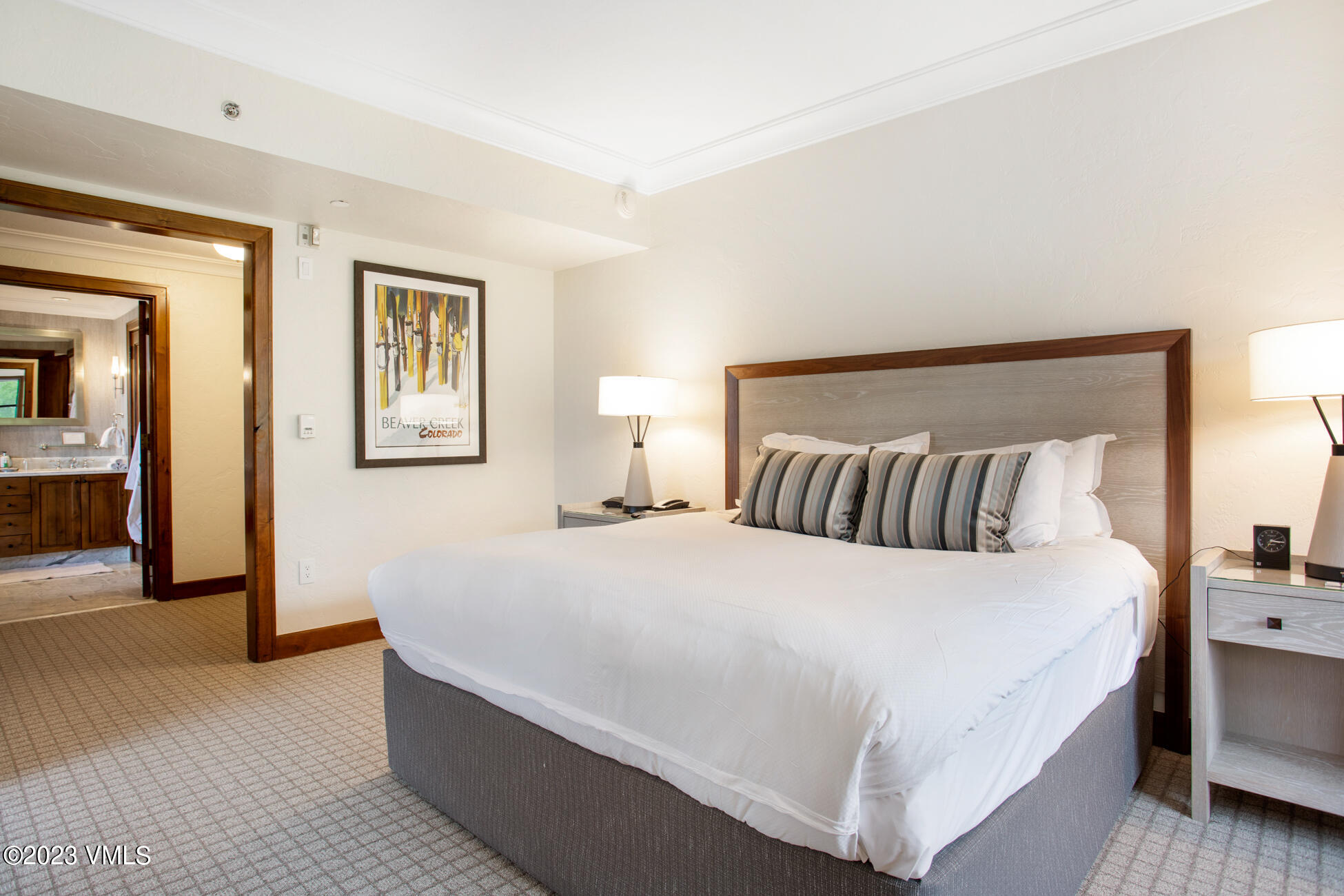 100 Bachelor Ridge Road, Unit 3214 Avon, CO 81620 - Photo 36 of 38 a bedroom with a large bed and a chandelier