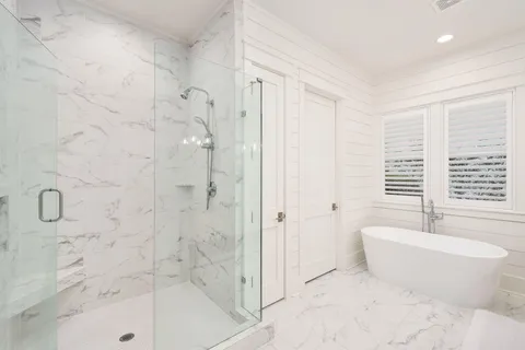 a bathroom with a bathtub and a shower