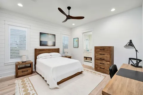 a bedroom with a bed a dresser and a couch