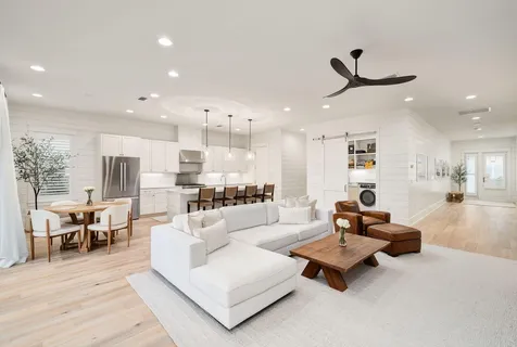a living room with furniture and kitchen view