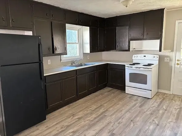 a kitchen with a stove sink and refrigerator
