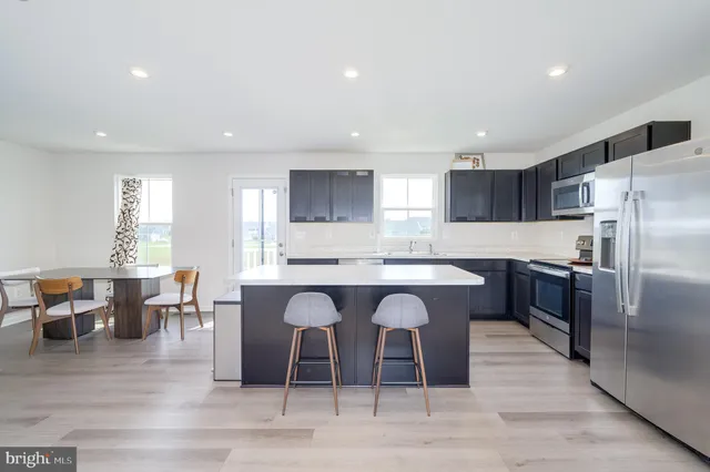 a large kitchen with a table and chairs