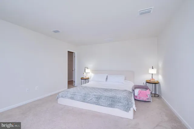 a bedroom with a bed and a lamp