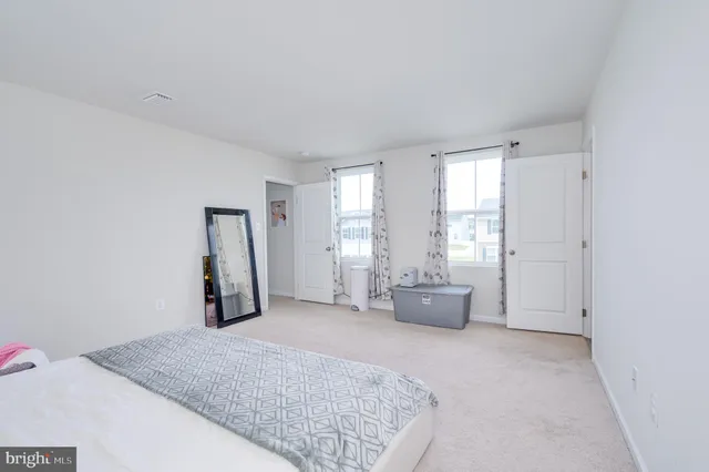 a view of walk in closet with clothes