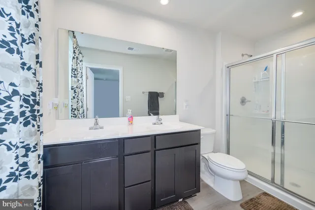 a bathroom with a shower a toilet and a sink