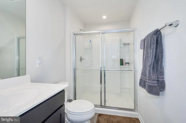 a bathroom with a sink mirror and a shower