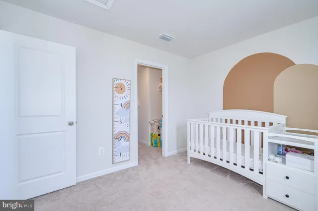 a bedroom with a bed and a hallway